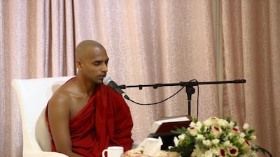 The monk recites versus of Buddha's teachings in Sinhalese before giving a sermon. Chris Whiteoak / The National