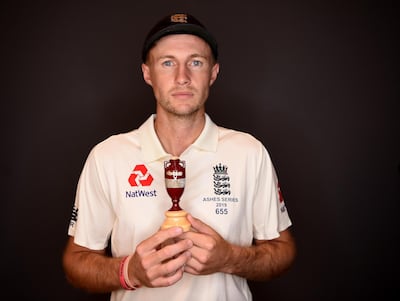 England captain Joe Root holds a replica of the Ashes urn as he poses for a portrait on Monday in London. Gareth Copley / Getty Images