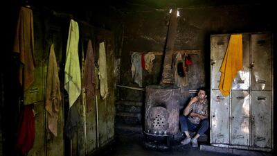 A coal miner smokes a cigarette during his break at a mine near the city of Zirab. Ebrahim Noroozi / AP Photo