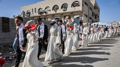 Palestinian brides and grooms gather for a mass wedding organised by the Turkish Humanitarian Relief Foundation in Gaza city. AFP