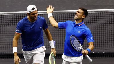 Novak Djokovic and Matteo Berrettini celebrate winning their doubles match against Team World's Alex de Minaur and Jack Sock. Reuters