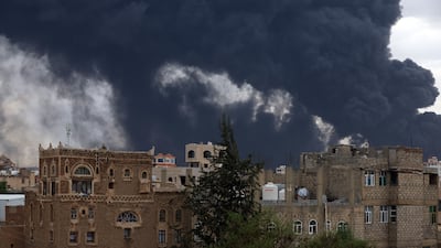 Clouds of smoke hang over buildings in Sanaa. EPA