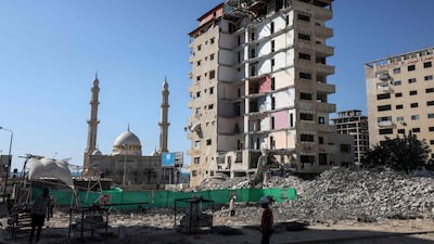Palestinian workers clear the rubble of a building destroyed by an Israeli air strike in in Gaza city. Israel launched strikes on a Hamas position on Monday after what it said was gunfire from the Gaza Strip. AFP