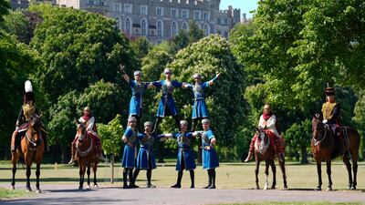Members of The King's Troop Royal Horse Artillery, the Equestrian Federation of Azerbaijan and the Royal Calvary of Oman pose for a photograph during a preview for the Royal Windsor Horse Show in Windsor, Berkshire, southern England. PA