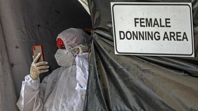 A health worker begins her shift at a Covid-19 centre in India's financial capital Mumbai. Cases are rising rapidly in several cities, resulting in a shortage of beds and oxygen supply. EPA