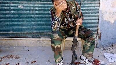 A Free Syrian Army fighter reveals his distress after his colleague was shot by Syrian soldiers during clashes in Aleppo. Goran Tomasevic / Reuter