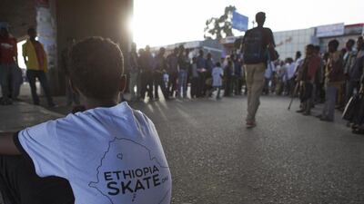 A young Ethiopian skateboarder sits in the Bole area of Addis Ababa on March 2, 2015. Zacharias Abubeker/AFP Photo