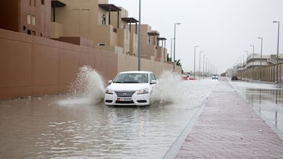 A car drives through a flooded street after the storm ay the Al Rayyana complex in the Khalifa City area of Abu Dhabi on March 9, 2016. Christopher Pike / The National