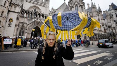 A demonstrator wears a Julian Assange mask as supporters stage a protest against his imprisonment outside the High Court in London. AP Photo