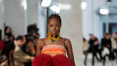 Japanese designer Tomo Koizumi has made ruffled fabric his signature, using satin for added shine. AP