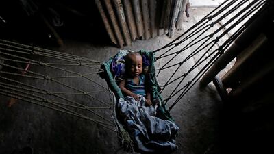 An infant sleeps in a hammock at a shelter in Kolkata, India. Rupak De Chowdhuri / Reuters