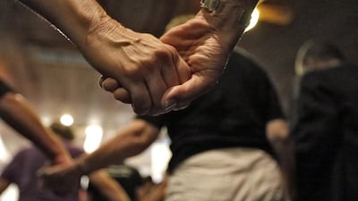 People at a prayer vigil at the Joy Metropolitan Church hold hands after a fatal shooting at the Pulse nightclub in Orlando, Florida. Chris O’Meara / AP
