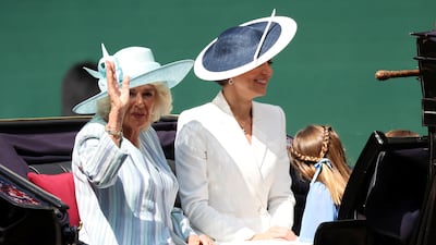 Left; Camilla, Duchess of Cornwall, who wore a blue striped dress coat and wide-brimmed blue hat. Right; Kate, Duchess of Cambridge. Reuters