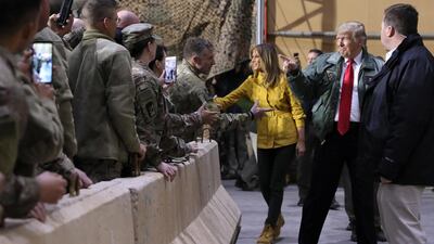 US President Donald Trump, with first lady Melania Trump, arrives to deliver remarks to US troops in an unannounced visit to Al Asad Air Base, Iraq. Reuters