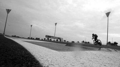 A shot of a rider cycling on a wet Yas Marina Circuit.