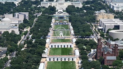The Ferris wheel of the Great American State Fair in the National Mall viewed from the Washington Monument with the US Capitol in the distance. The fair celebrates the 250th anniversary of the US Declaration of Independence. AFP