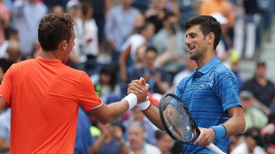 Novak Djokovic shakes hands with Roberto Carballes Baena after winning their match 6-4, 6-1, 6-4. AFP