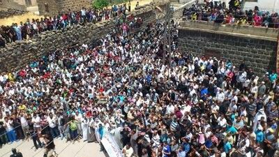 Hundreds of mourners attend the funeral procession of victims killed by violence in Dael in the southern province of Deraa.
