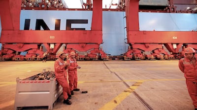 Workers beside the Marsk Majestic at the Yangshan Deep Water Port. Aly Song / Reuters
