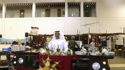 Nasser Sultan bin Yousef with his mobile Land Rover cafe, which sells traditional Emirati fare. Jeffrey E Biteng / The National