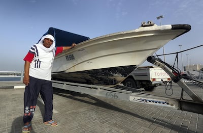 Yousef Baroun next to his damaged boat. Satish Kumar for The National