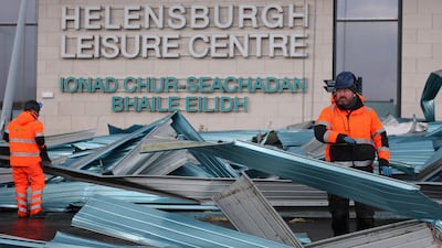 Workers clear debris from a roof blown off a leisure centre during storm Eowyn in Helensburgh, Scotland. Getty Images