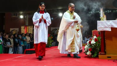Fr Chito Bunda Bartolo, parish priest of St Joseph's Church in Abu Dhabi, leads the 8pm Christmas Eve mass on December 24. Victor Besa / The National