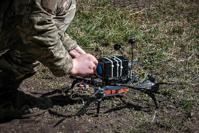 A Ukrainian drone pilot prepares an interceptor drone for take-off. Photo: EPA