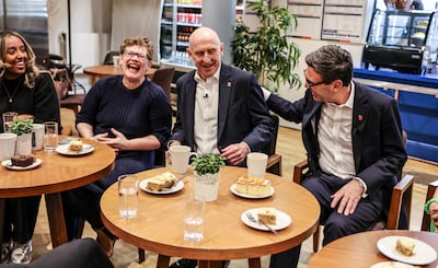 British Prime Minister Andy Burnham and Chancellor of the Exchequer John Healey meet residents in a Westminster cafe. Reuters