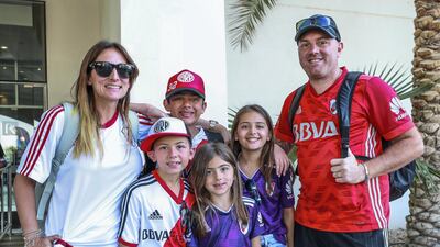Juan Romo and his family wait for their shuttle to the Hazza Bin Zayed Stadium.