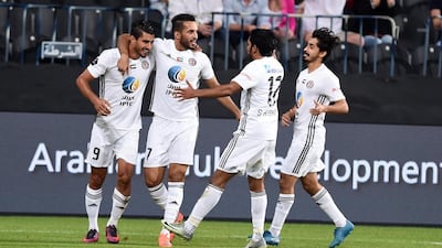 Ali Mabkhout, second left, celebrates with teammates after scoring for Al Jazira against Al Ahli. Courtesy AGL