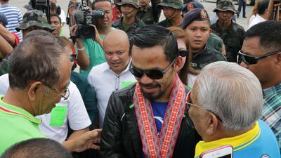 Manny Pacquiao, centre, is greeted by supporters upon arrival at General Santos city airport, southern Philippines after his defeat to Jeff Horn. Kim Tiblani / EPA