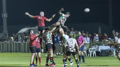 Action from the match between Abu Dhabi Harlequins, green and white, and Dubai Exiles, red, on Friday night at The Sevens. Antonie Robertson / The National / September 2, 2016