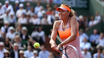 Maria Sharapova of Russia returns a shot during her French Open women's singles semi-final match against Eugenie Bouchard of Canada at Roland Garros on June 5, 2014 in Paris. Matthew Stockman / Getty Images