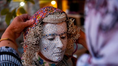 Buqaj stands after receiving a traditional face painting. AFP