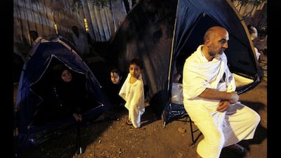 A family rests after arriving at Mount Arafat. Amr Abdallah Dalsh / Reuters