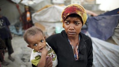 A woman from the Akhdam community holds her son in a slum area in Yemen's south-western city of Taez. Reuters