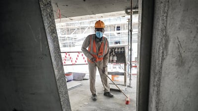 A worker at a under-construction site. Victor Besa / The National
