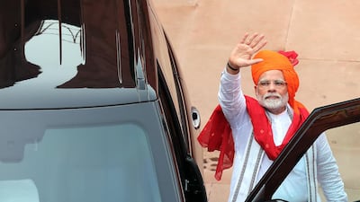 Mr. Modi greets people after his speech. EPA