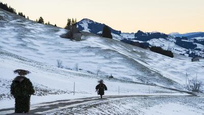 So-called Silvesterchlaeuse (New Years Clause) walk in Urnaesch, Switzerland to offer best wishes for the New Year (following the Julian calendar) to the farmers in this region. After their performance of singing and dancing, the Silvesterchlaeuse receive food, hot drinks or money. Gian Ehrenzeller / EPA