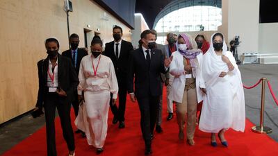 French President Emmanuel Macron arrives with Sudanese civil representatives at a session of the summit to support Sudan, at the Grand Palais Ephemere in Paris, France. EPA