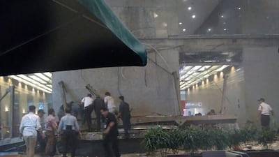 This photo received from Amailia Putri Hasniawati via WhatsApp shows people looking for victims after an internal balcony collapsed at Indonesia's stock exchange in Jakarta. Amailia Putri Hasniawati / AFP