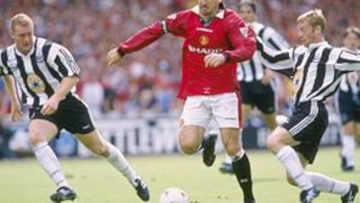 Manchester United's Eric Cantona, centre, holds off a challenge from Newcastle's David Batty, right, in the 1996 Charity Shield.