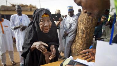 An elderly Nigerian woman arrives to validate her voting card using a fingerprint reader, prior to casting her vote later in the day in Daura ,the home town of the main opposition presidential candidate, Muhammadu Buhari, on March 28, 2015. Ben Curtis / AP Photo