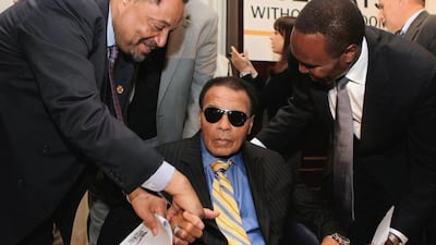 This file photo taken on May 24, 2011 shows Legendary heavyweight boxing champion Muhammad Ali (C) is greeted after a news conference at the National Press Club in Washington. Yuri Gripas / AFP