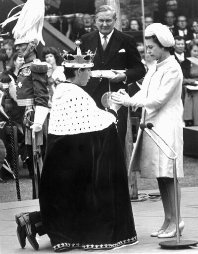 Queen Elizabeth holds the hands of her 20-year-old son during his investiture as Prince of Wales in 1969. AFP