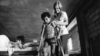 A Red Cross nurse from Sweden takes care of a boy shot in the heel by a sniper, on September 9, 1976, at a hospital in the Coral Beach Hotel, on the road between Beirut and Saida. AFP