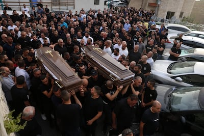 Mourners carry the coffins of two of the five Arab Israelis killed in early June. AFP