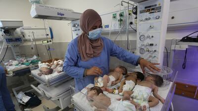 A nurse cares for prematurely born Palestinian babies that were brought from Al Shifa Hospital in Gaza city. AP