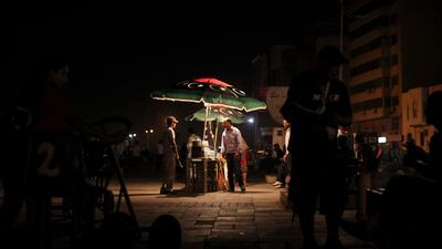 People sell food on the street as they celebrate what they believe is the nearly end of the military conflict against Gadhafi's regime at the rebel-held town of Benghazi, Libya, early Tuesday, Aug. 23, 2011. World leaders said Monday the end is near for Moammar Gadhafi's regime and began looking at Libya's future without the man who has held power there for 42 years. (AP Photo/Alexandre Meneghini)